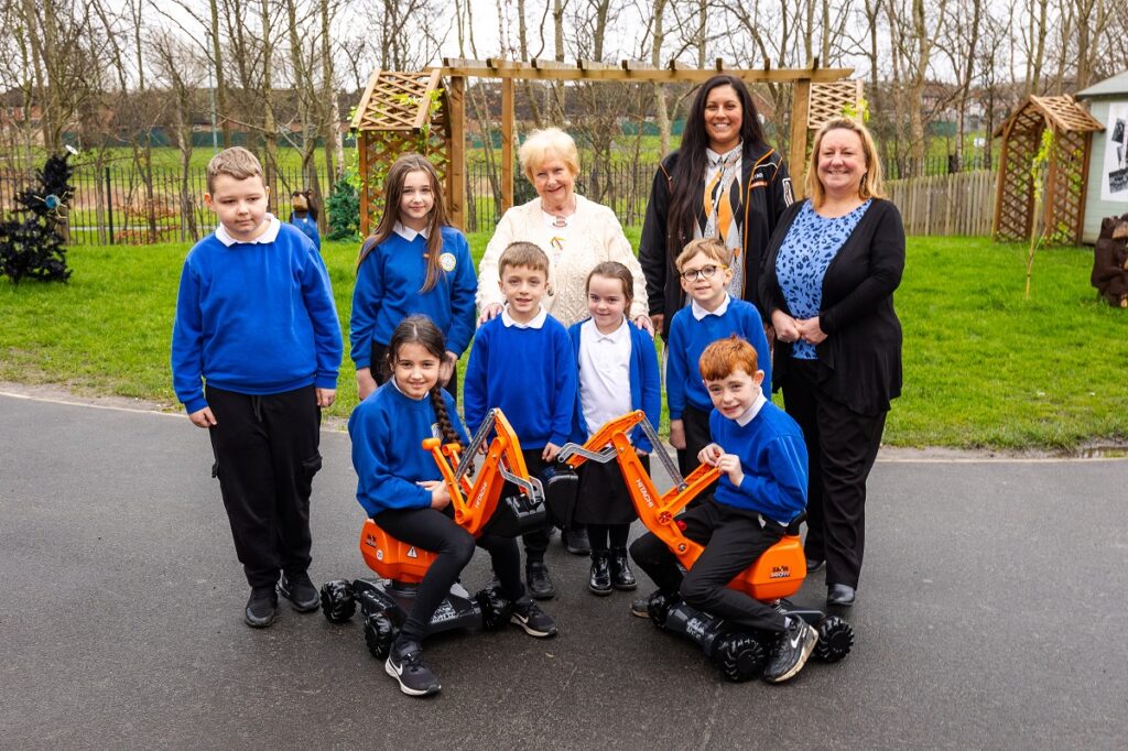 Hitachi's Social Responsibility Co-ordinator Jade Hucks, Cllr Margaret Meling, South Tyneside Council’s lead member for Economic Growth and Transport with Headteacher, Nicola Fullard and children from Toner Avenue Primary School.