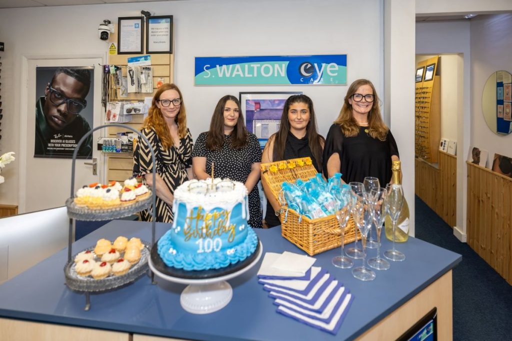 S. Walton Eyecare’s Kaye Winship and staff celebrating the firm's centenary
